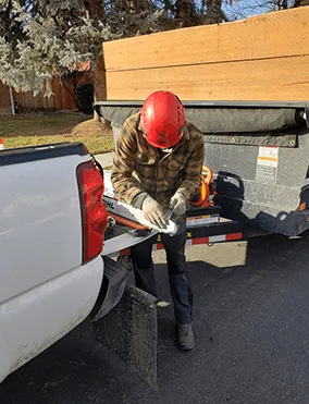 An image of a man fixing chainsaw blade